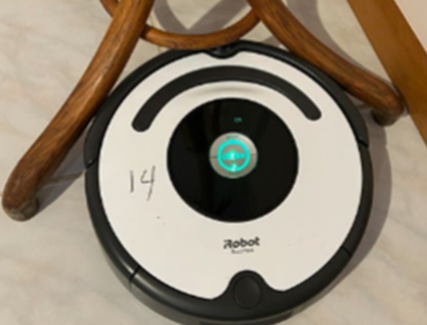 This Roomba is trying so hard to clean under this stool but can't because it's too fat