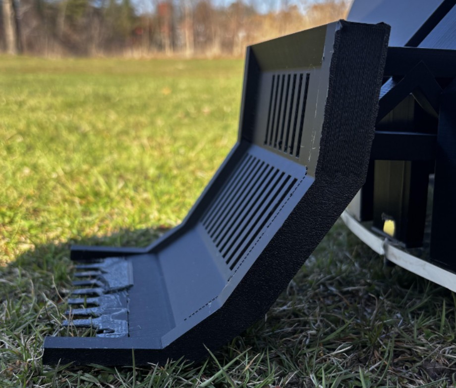 Scoop is mounted at the fron of the robot and is shaped to funnel and collect soft material